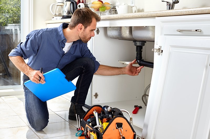 A photorealistic image of a plumber inspecting a newly repaired pipe, highlighting the safety and security aspect of the service. The image should be in a residential bathroom, featuring modern plumbing fixtures and a focus on detail and craftsmanship.